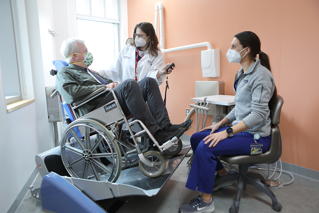 Dentists with patient in wheelchair