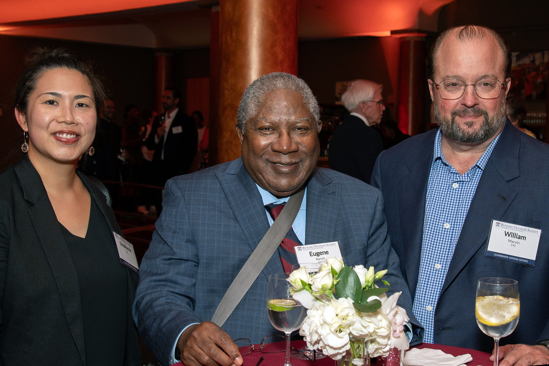 Stephanie Lin (at left), Eugene Aaron, WG’73 (center), and William Marvin, C’92, enjoyed refreshments and conversation during the Benjamin Franklin Society reception