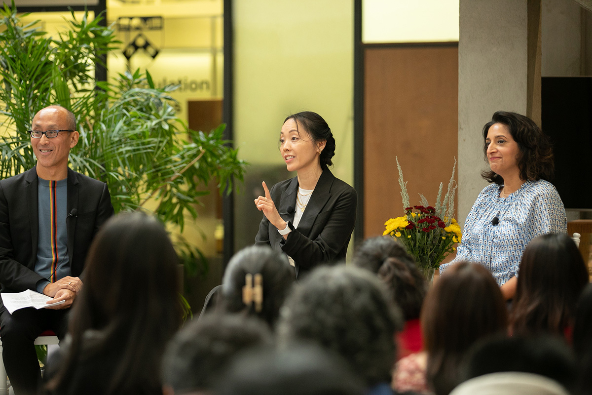 Three people sit in a row to speak during a panel discussion