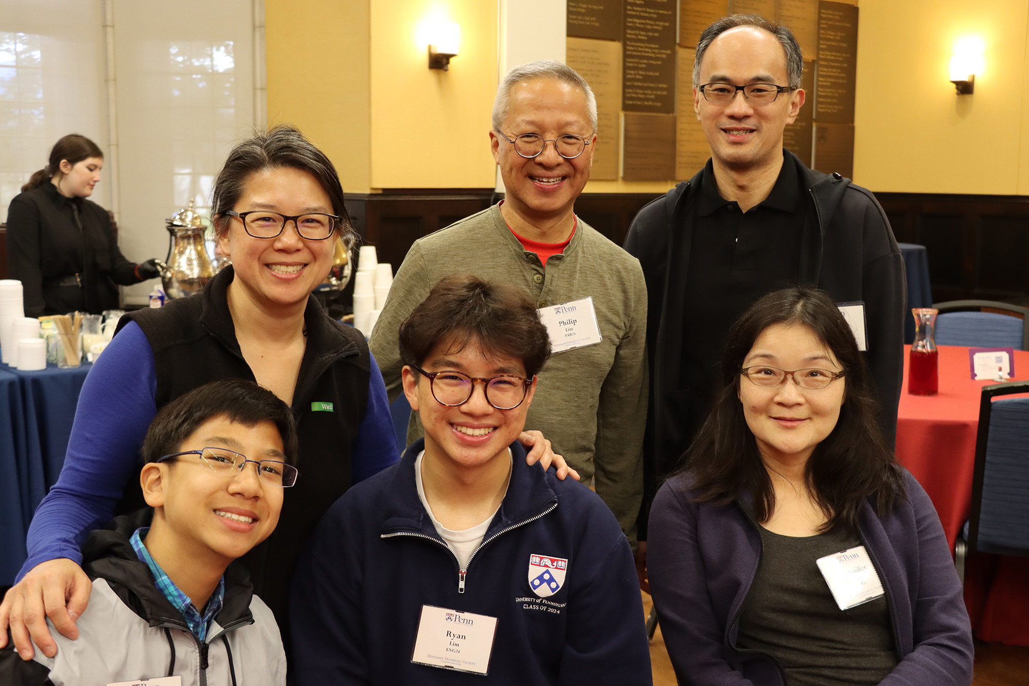 A Penn alumni family smiles for the camera during the 2022 Homecoming Brunch for members of the Benjamin Franklin Society at the University of Pennsylvania.