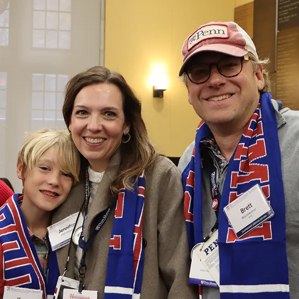 A multigenerational family gathered at a the annual Benjamin Franklin Society Brunch at the University of Pennsylvania's Homecoming Weekend, all smiling broadly and decked out in Penn colors.