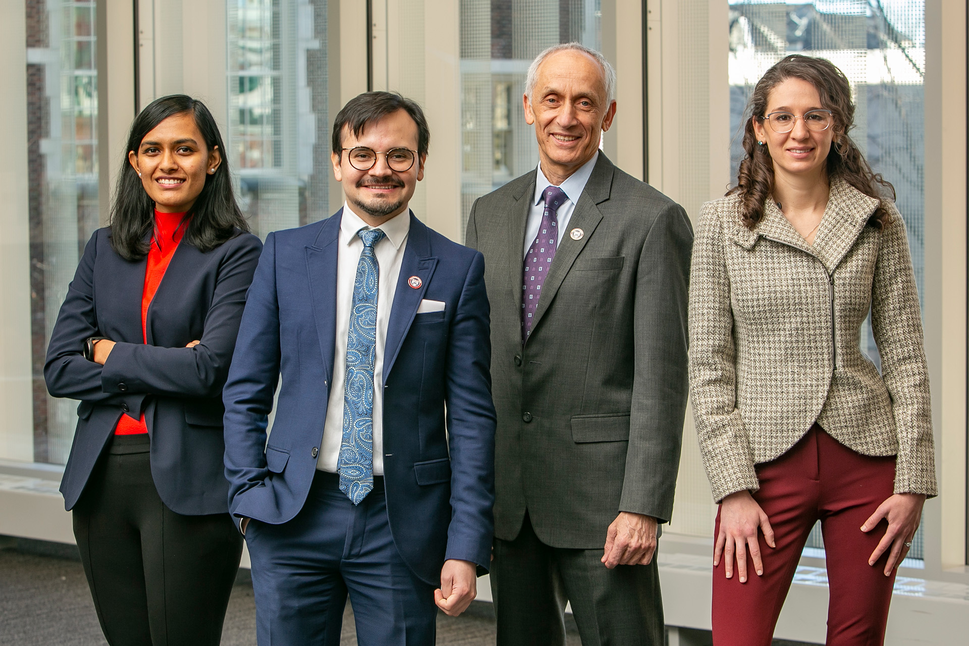 Four members of Penn Dental's Center for Integrative Global Oral Health, Ankita Shashikant Bhosale, Alonso Carrasco-Labra, Michael Glick, and Olivia Urquhart, pose together as a group. Photo credit: Kevin Monko.