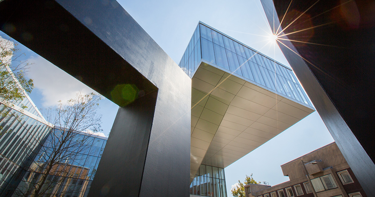 An exterior view looking upward at the Singh Center for Nanotechnology at the University of Pennsylvania, seen from within the 1962 sculpture by Anthony Smith titled 
