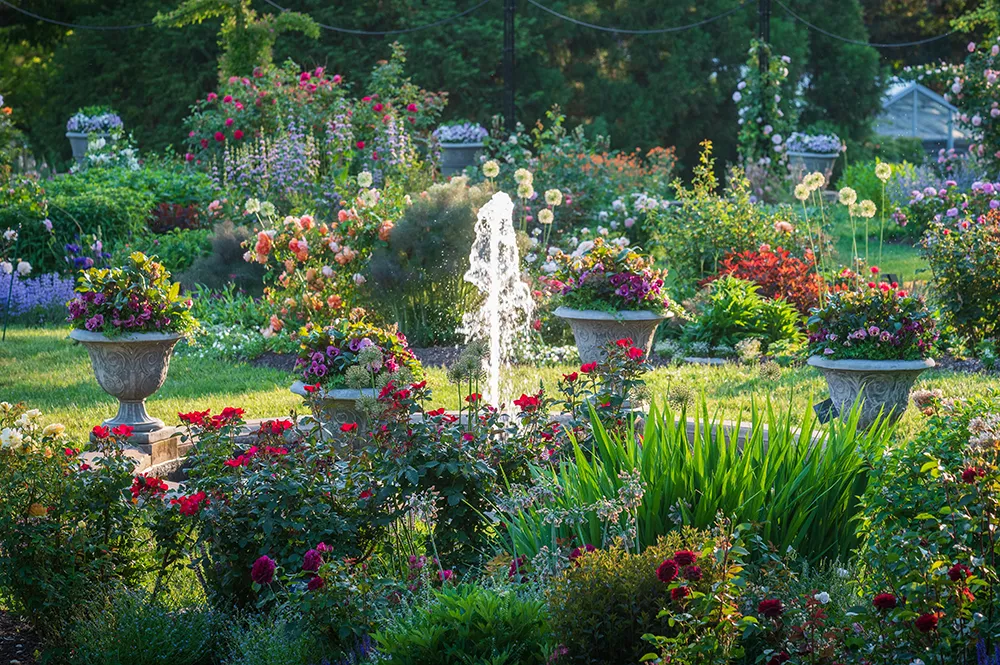 A garden fountain surrounded by vibrant flowers and greenery at the Morris Arboretum & Gardens.
