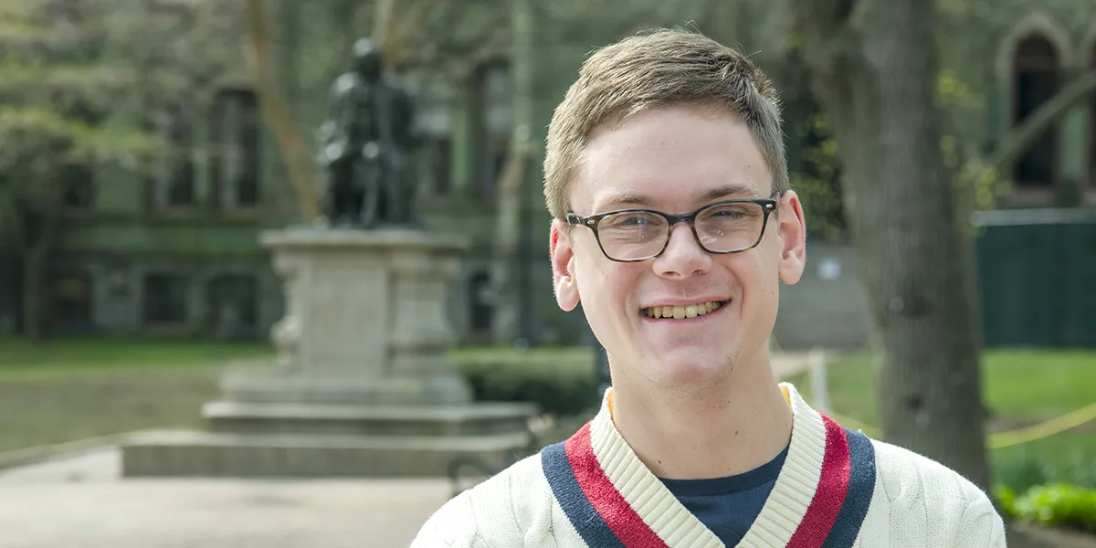 Penn student smiling on College Green, representing the individual success stories supported by The Penn Fund.