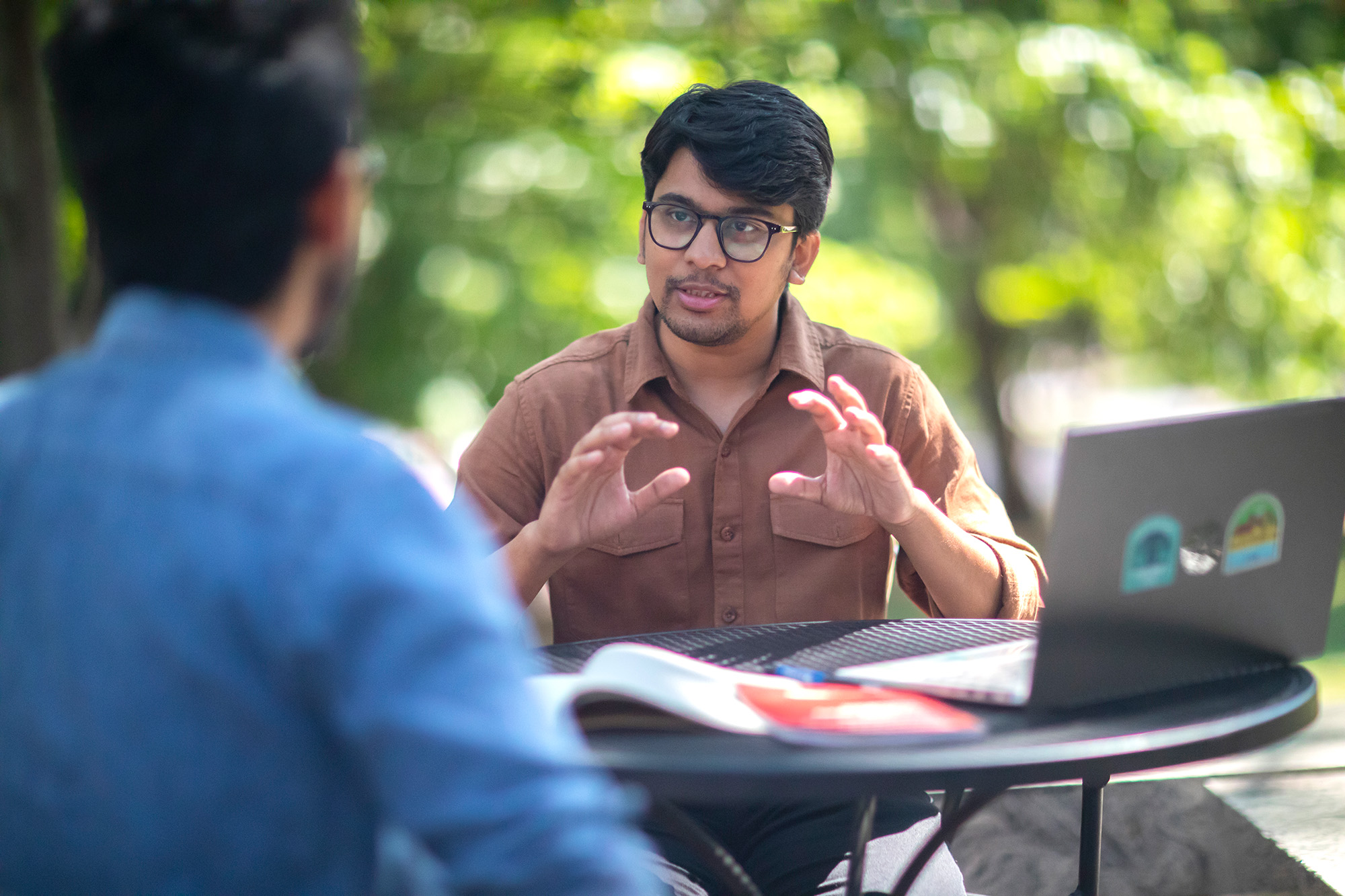 Sparsh Maheshwari, a student in the Social Justice Scholars Program at the University of Pennsylvania School of Social Policy and Practice, speaks with a fellow student.